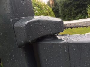 Aluminium cover on a gate hinge