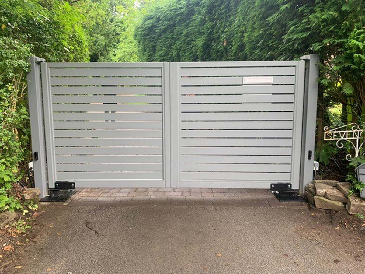 white aluminium driveway gates fixed to aluminium posts