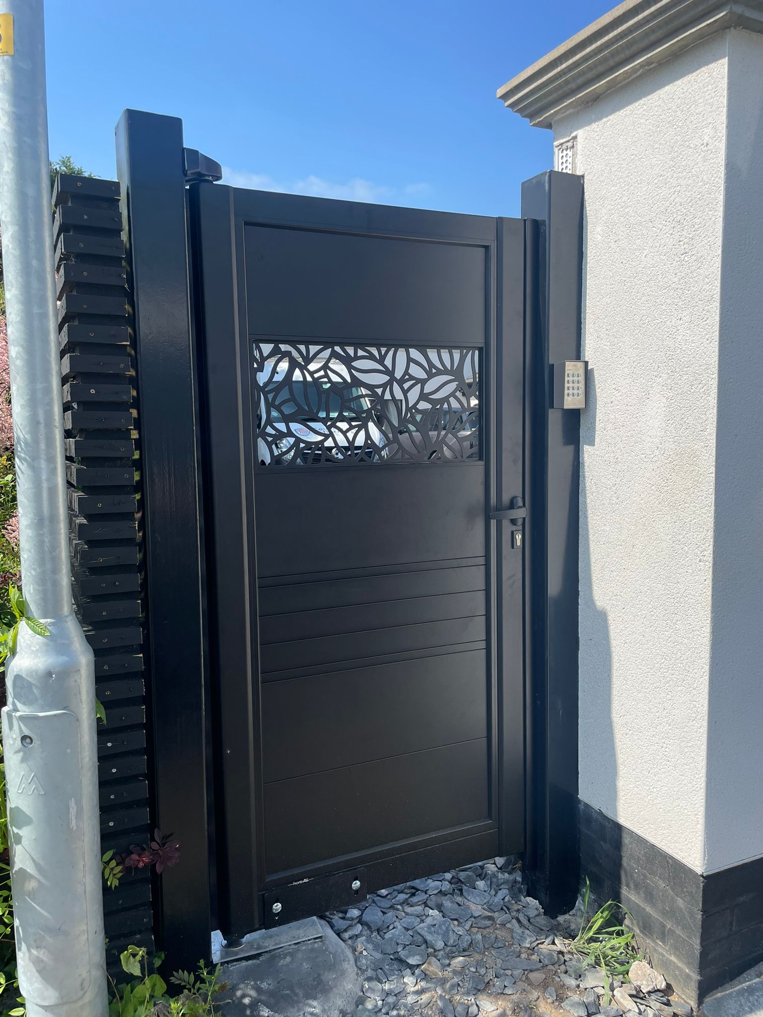 Aluminium Garden Gate with Lasercut pattern in black fitted to white pillars